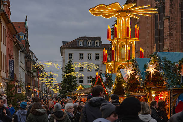 German traditional Christmas market and decoration in the evening Heidelberg, Germany - December 4, 2016: browsing and shopping at the German traditional Christmas market in the decorated pedestrian area of Heidelberg old town. heidelberg germany stock pictures, royalty-free photos & images