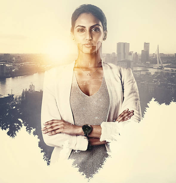 Portrait of an attractive young businesswoman superimposed over a cityscape