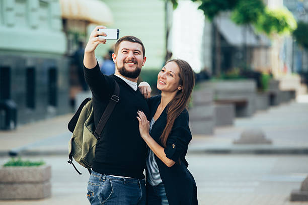 istock Male and female make selfie. 628308122