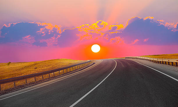 istock sunset over the country highway 628308348