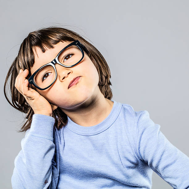 istock serious preschooler with eyeglasses for thought, imagination, confusion or headache 628309866