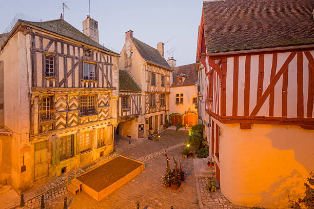 Square with half-timbered houses, in the medieval village Noyers Sunrise view of a square (place de la petite etape aux vins), with half-timbered houses, in the medieval village Noyers-sur-Serein, Burgundy, France avallon stock pictures, royalty-free photos & images