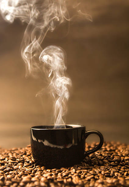 istock warm black cup of coffee on  roasted coffee beans 628316564