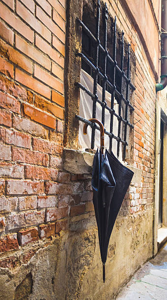 istock parasol by the window on the background of old brick 628317056