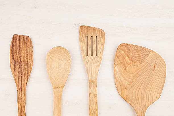 istock Design concept mock up empty beige spoons  white wood background. 628325974
