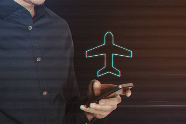 istock Young Business Man Using Smartphone with Airplane Icon 628326610