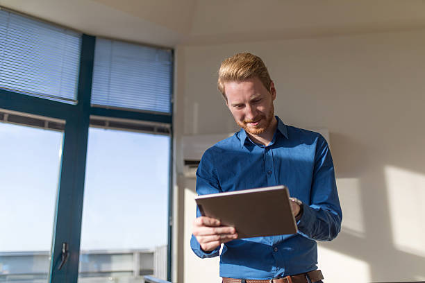 istock Successful businessman using digital tablet and surfing the net 628328468