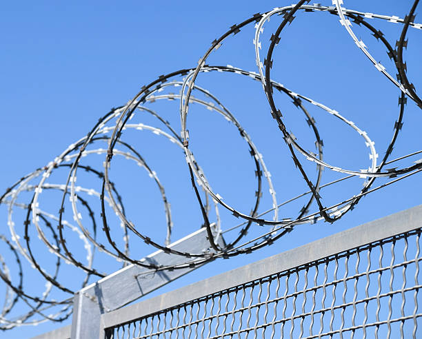 istock Barbed wire fence of the prison 628329838