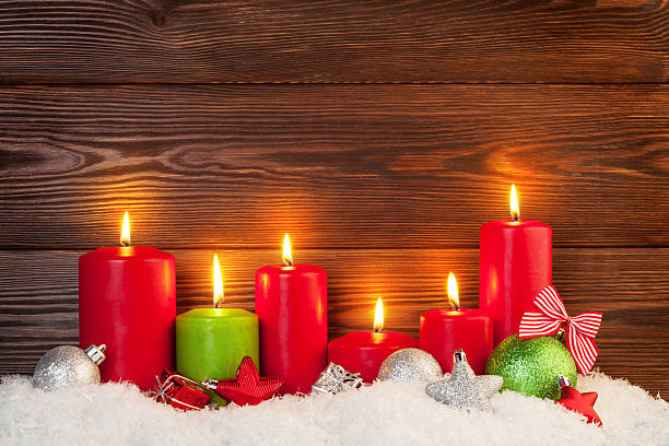 istock Christmas candles in snow 628330120