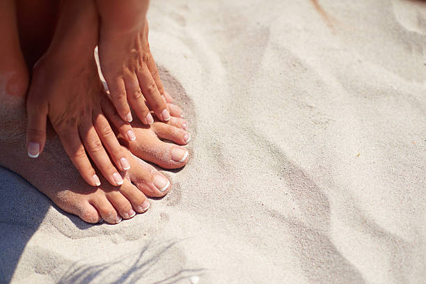 istock Manicure and pedicure over sand background on the beach 628332256