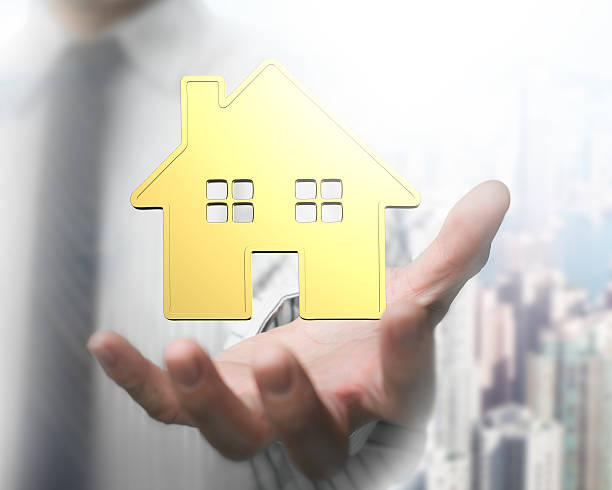 istock Man's hand showing golden house 628333548