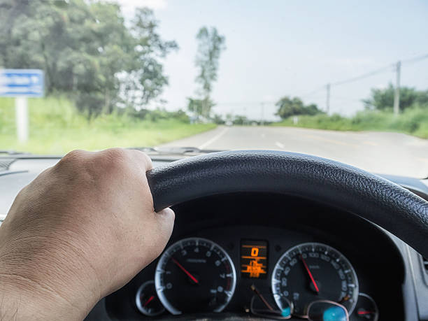 istock Driver's hand on the steering wheel while driving car 628333830
