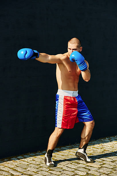 istock Boxer shorts and gloves practicing on the street 628334500
