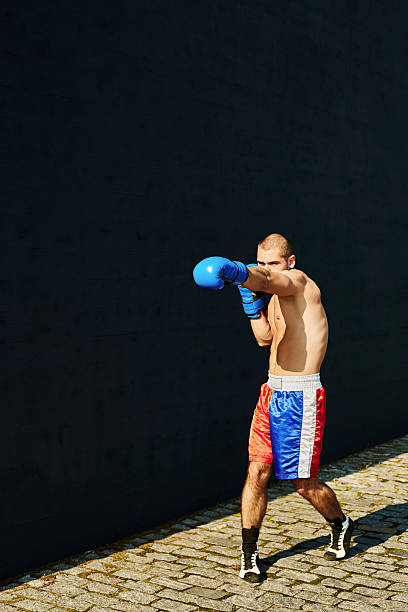 Boxer shorts and gloves practicing on the street