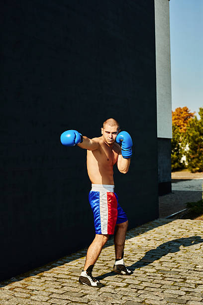 istock Boxer shorts and gloves practicing on the street 628334664
