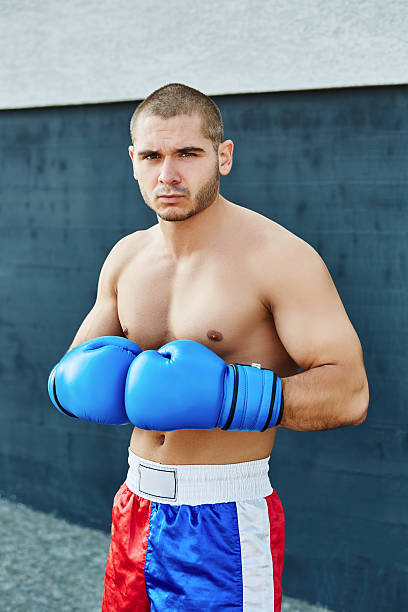 istock Boxer shorts and gloves practicing on the street 628334736