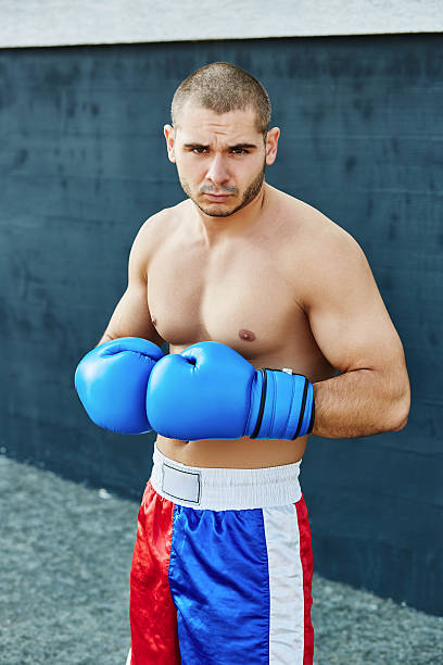 istock Boxer shorts and gloves practicing on the street 628334800