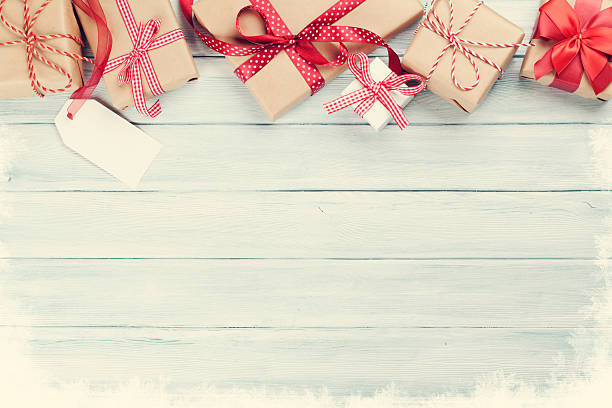 istock Christmas wooden background with gift boxes and snow 628335190