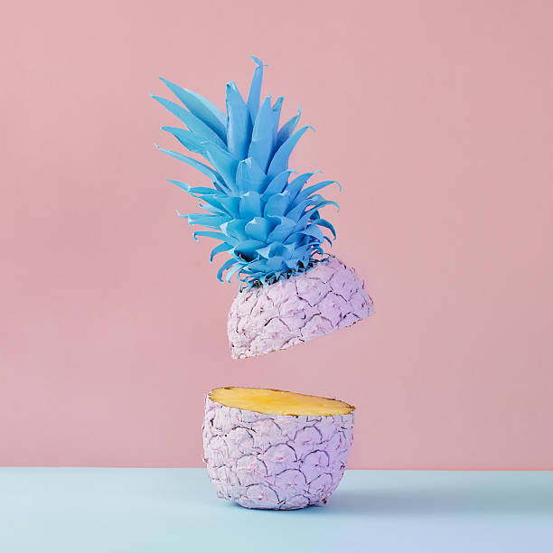 istock Pink pineapple on yellow background. Minimal style. Food concept 628335310