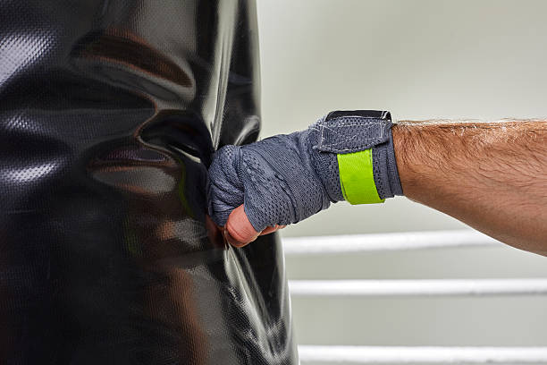 istock Young boxer training his skills hitting a punching bag. 628335408