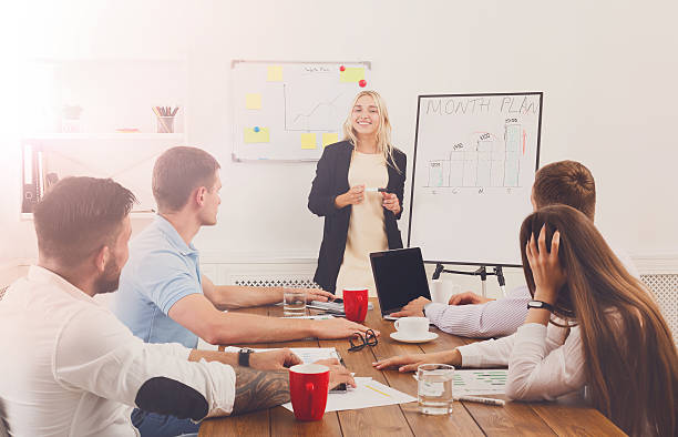 istock Project presentation. Young hipsters businessmen and women at mo 628342200