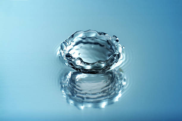 istock Water splashing droplets with water ripples ,Blue Tone 628343304