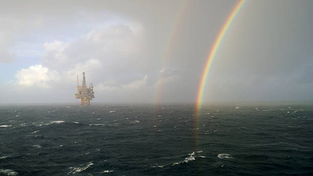 rainbow  - oil rig sea oil storm stock-fotos und bilder