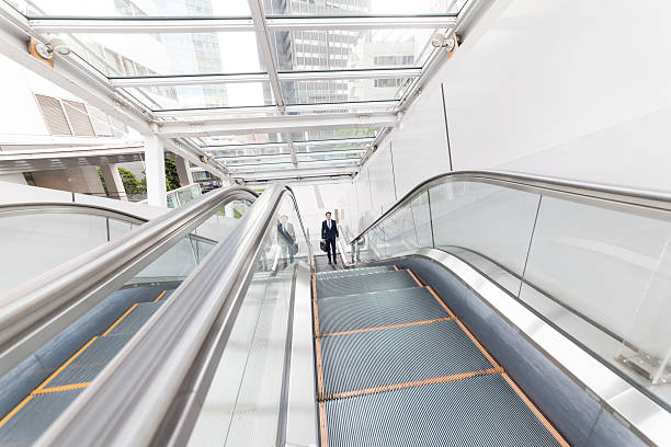 istock Businessman moving up on subway escalator 628347184