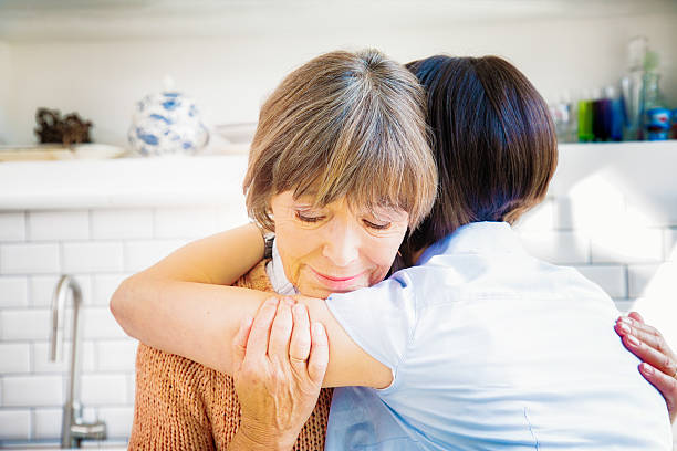 istock Senior mother hugs daughter while grieving 628349242