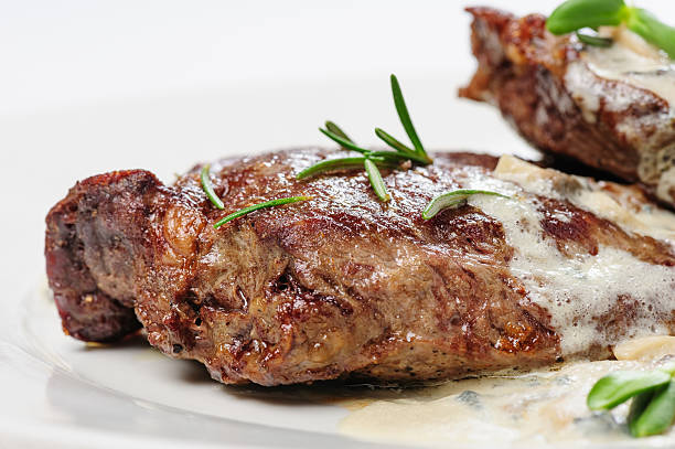 istock roasted beef steaks with rosemary under white sauce 628350084