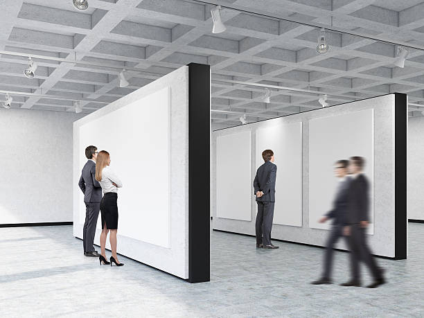 istock People looking at pictures in art gallery with interesting ceili 628350128