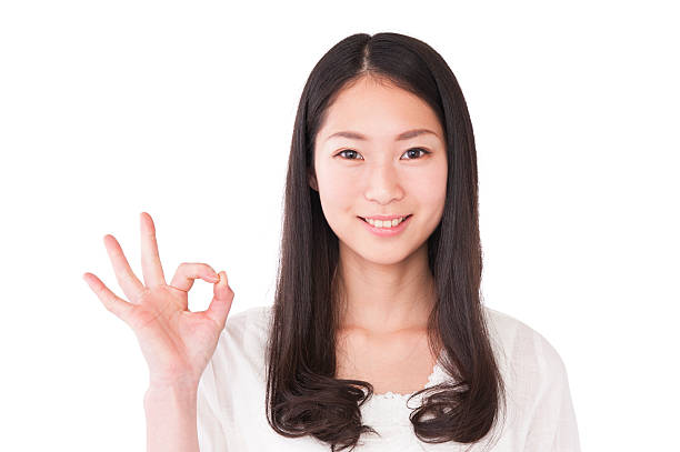 istock Asian young woman show ok hand saign 628356312