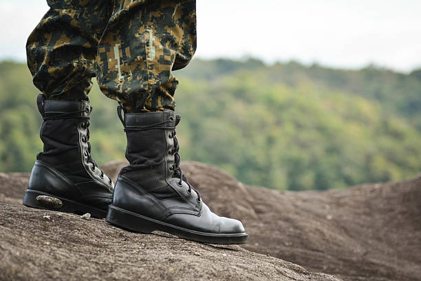 istock Soldier stand on the rock in nature background 628356542