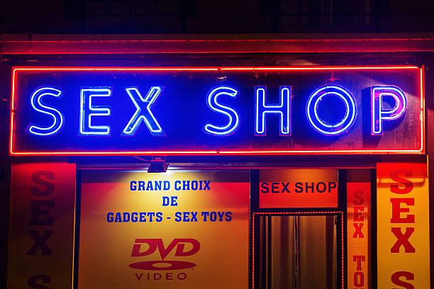 sex shop at Pigalle district, Paris, France Paris, France - October 20, 2016: sex shop at Pigalle district, Paris. Pigalle is famous for being a tourist district with many sex shops theatres and adult shows on Place Pigalle and the main boulevards place pigalle stock pictures, royalty-free photos & images