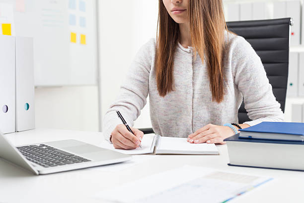 istock Secretary in cardigan in her office 628356806