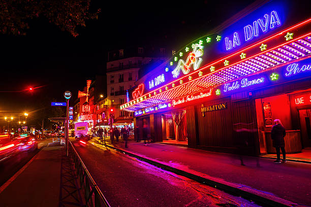 night scene in Pigalle district, Paris, France Paris, France - October 20, 2016: night scene in Pigalle district, with unidentified people. Pigalle is famous for being a tourist district with many sex shops theatres and adult shows on Place Pigalle and the main boulevards place pigalle stock pictures, royalty-free photos & images