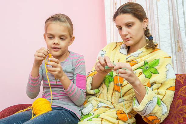 istock Mom and daughter seven-year-knit on the needles 628357270