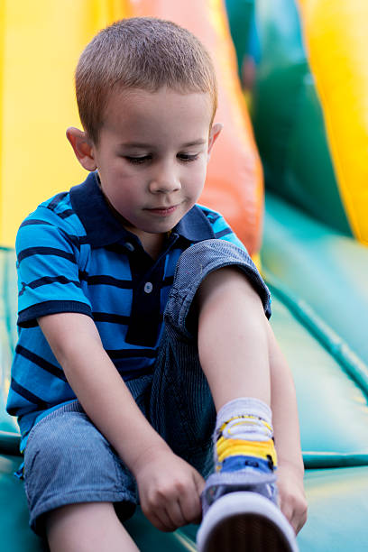 istock Little boy puts on his shoes 628357504