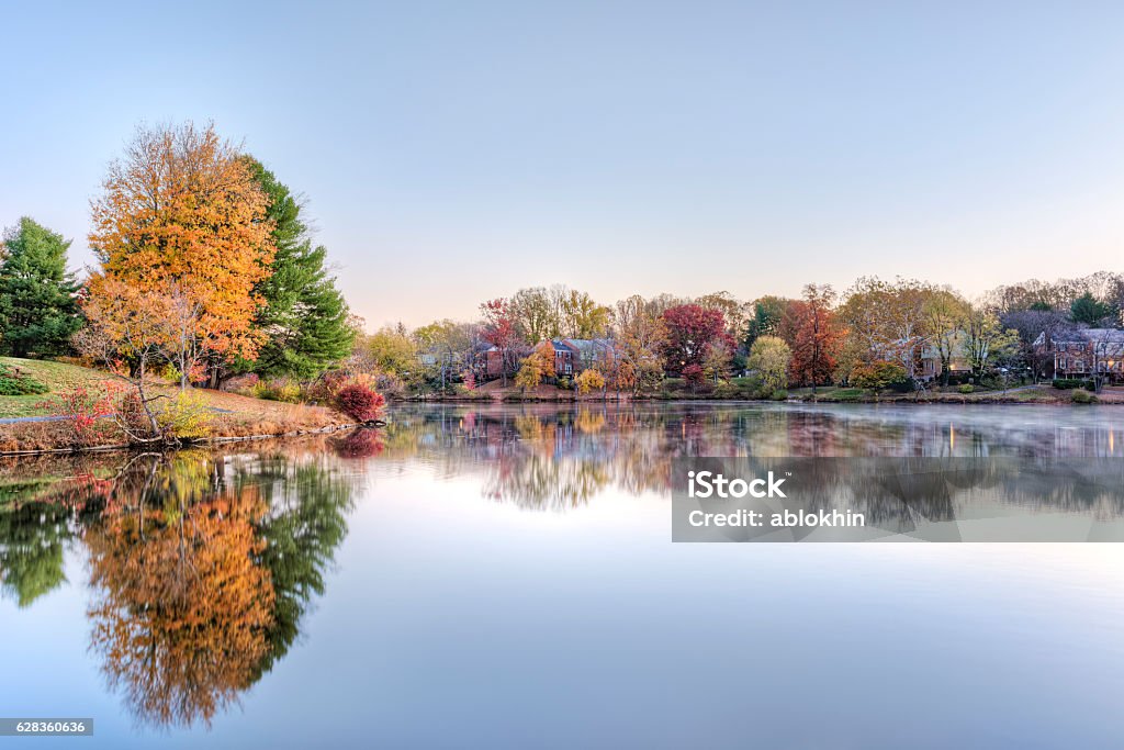 Sunrise on Braddock lake with reflection in autumn Sunrise on Braddock lake in Burke, Virginia, USA with reflection in autumn and orange tree Virginia - US State Stock Photo