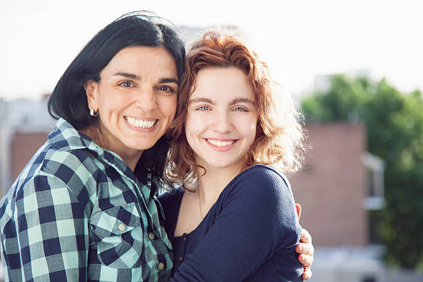 mother and teenager daughter embracing
