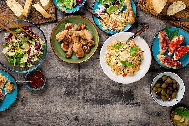 istock Risotto, roasted chicken legs and snacks on a wooden table 628362698