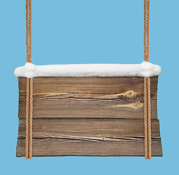 istock Wooden signboard with snow hanging on double ropes 628366002