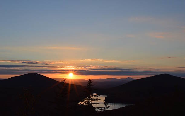 istock Sunset over mountains, lake and pine trees, Vermont 628367242
