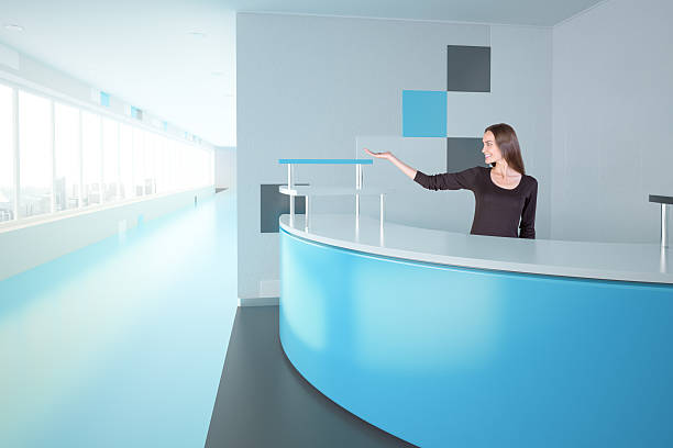istock Woman at blue reception desk 628367732