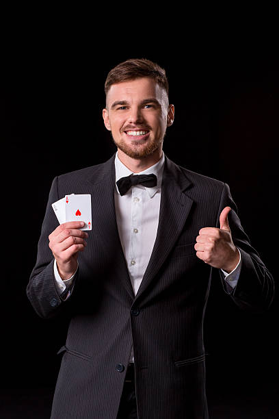 istock man in a suit posing with cards 628368168