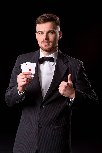 istock man in a suit posing with cards 628368296