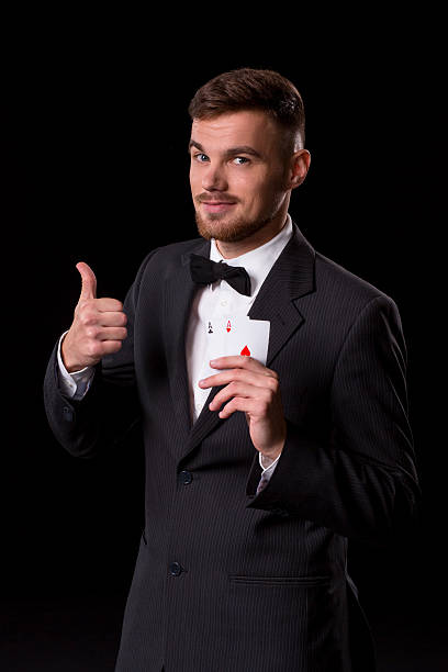 istock man in a suit posing with cards 628368760
