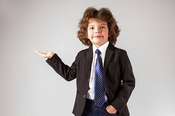 istock Little curly boy is holding up a hand, palm up 628370332