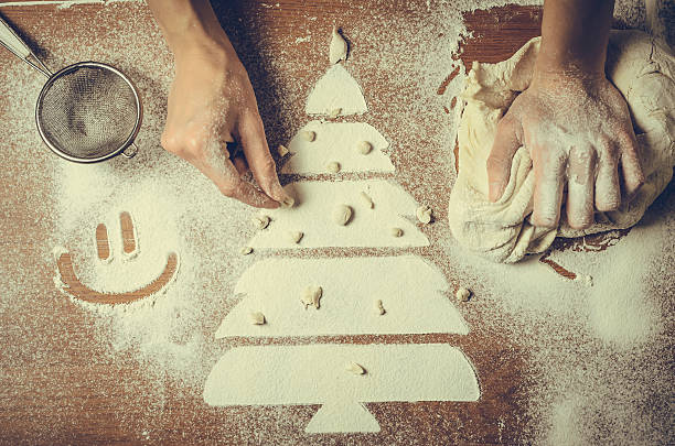 istock Female hands pressing dough and make the Christmas cookies 628388844