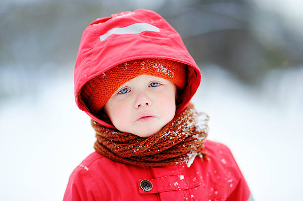 istock Outdoors portrait of sad crying little boy in winter 628389934